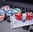 A set of red dice and poker chips are placed on top of a credit card, which is situated on a laptop keyboard. The poker chips are in various colors, including blue, green, red, and white.